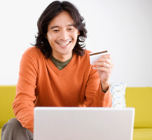 Man holding credit card using a laptop